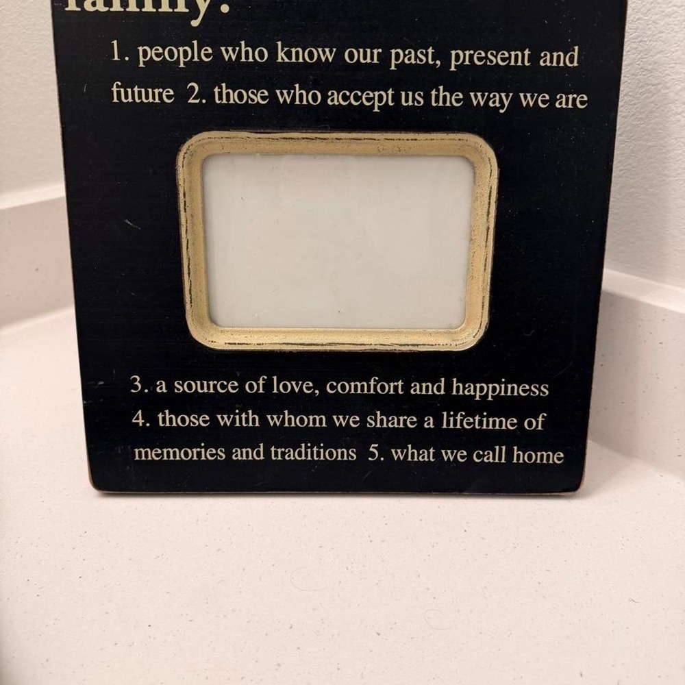 Black wooden picture frame with a quote about family